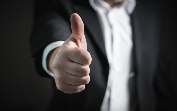 Businessman showing thumbs up